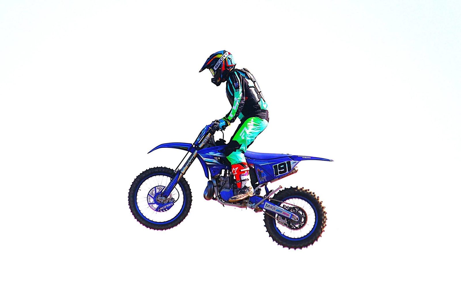 Jake in the air on a blue Yamaha dirt bike, number 191, wearing teal and black gear